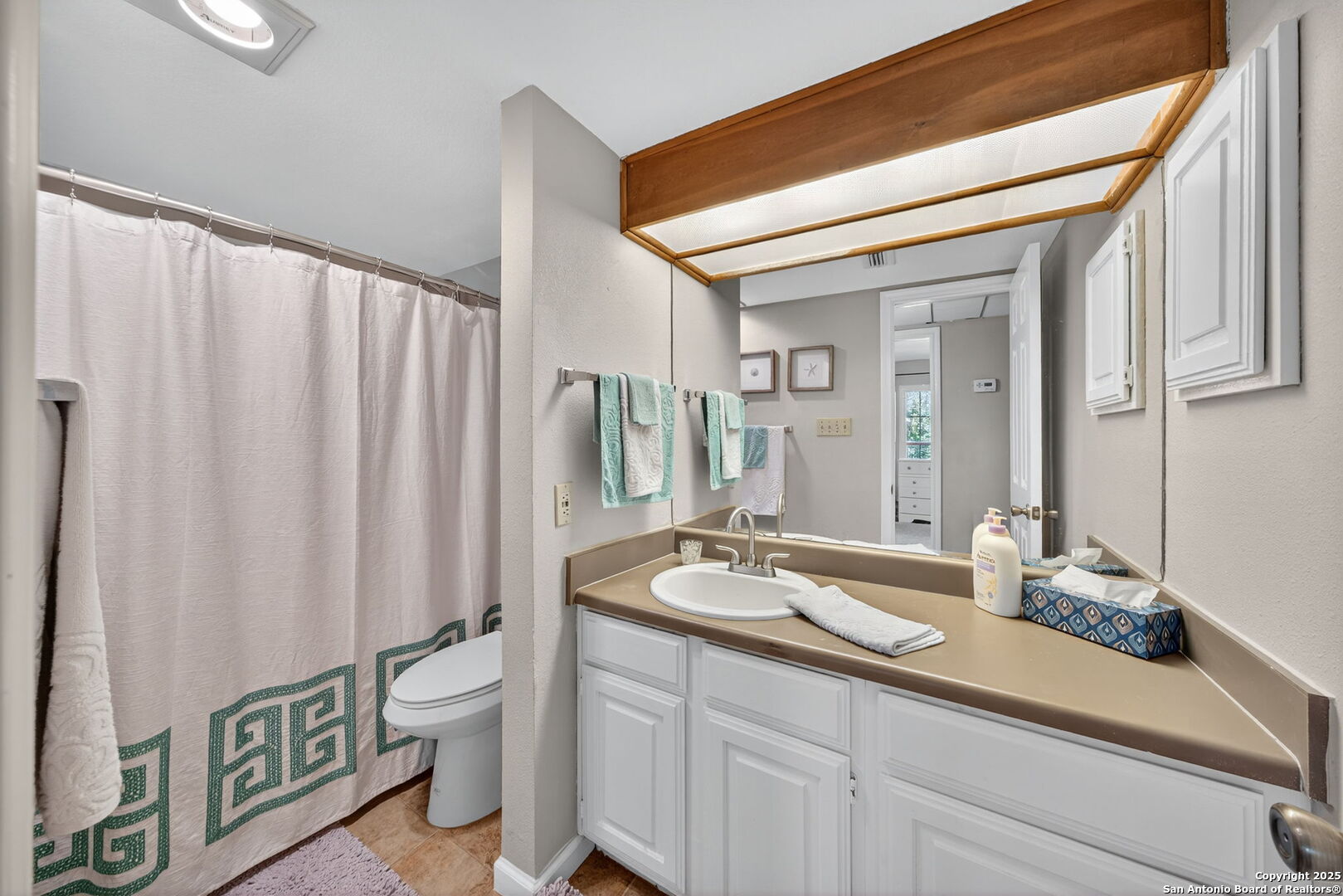 13130 Blanco Road, Unit 206 San Antonio, TX 78216 - Photo 9 of 12 a spacious bathroom with a double vanity sink toilet and a mirror