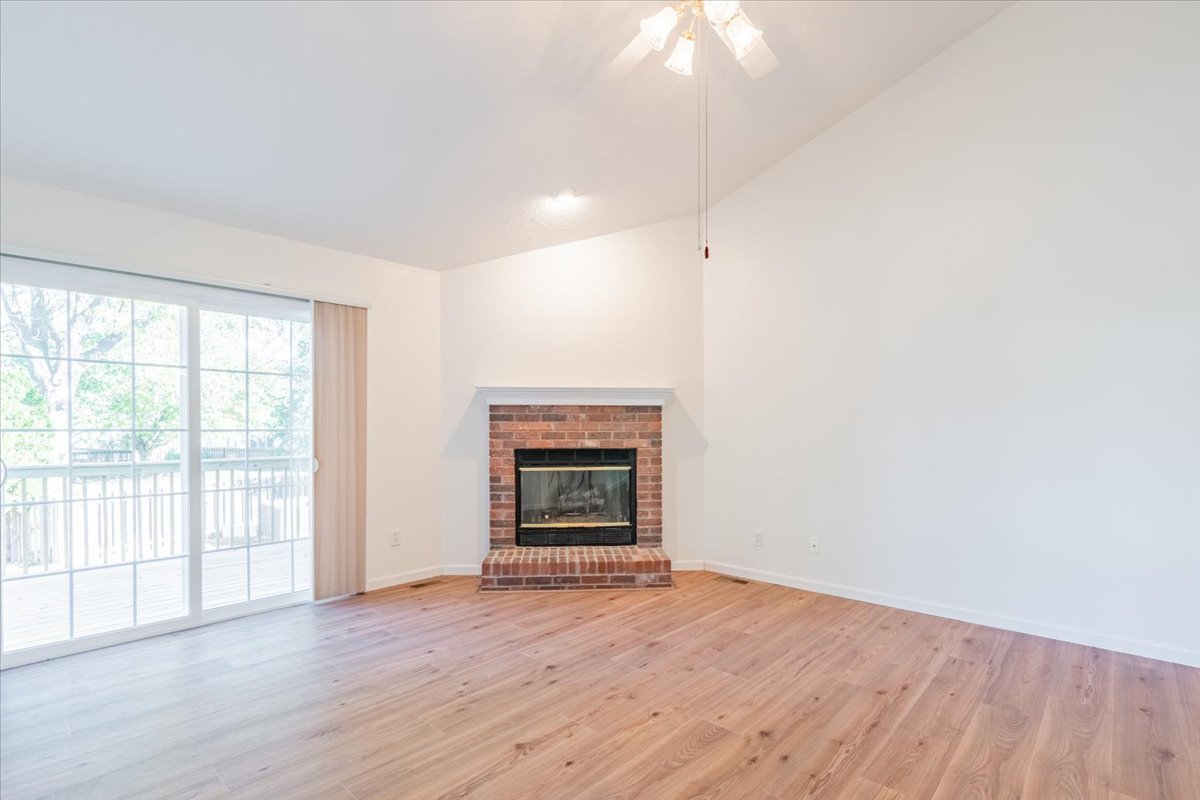 107 North Blair Drive, Unit 8 Normal, IL 61761 - Photo 12 of 29 an empty room with wooden floor fireplace and windows