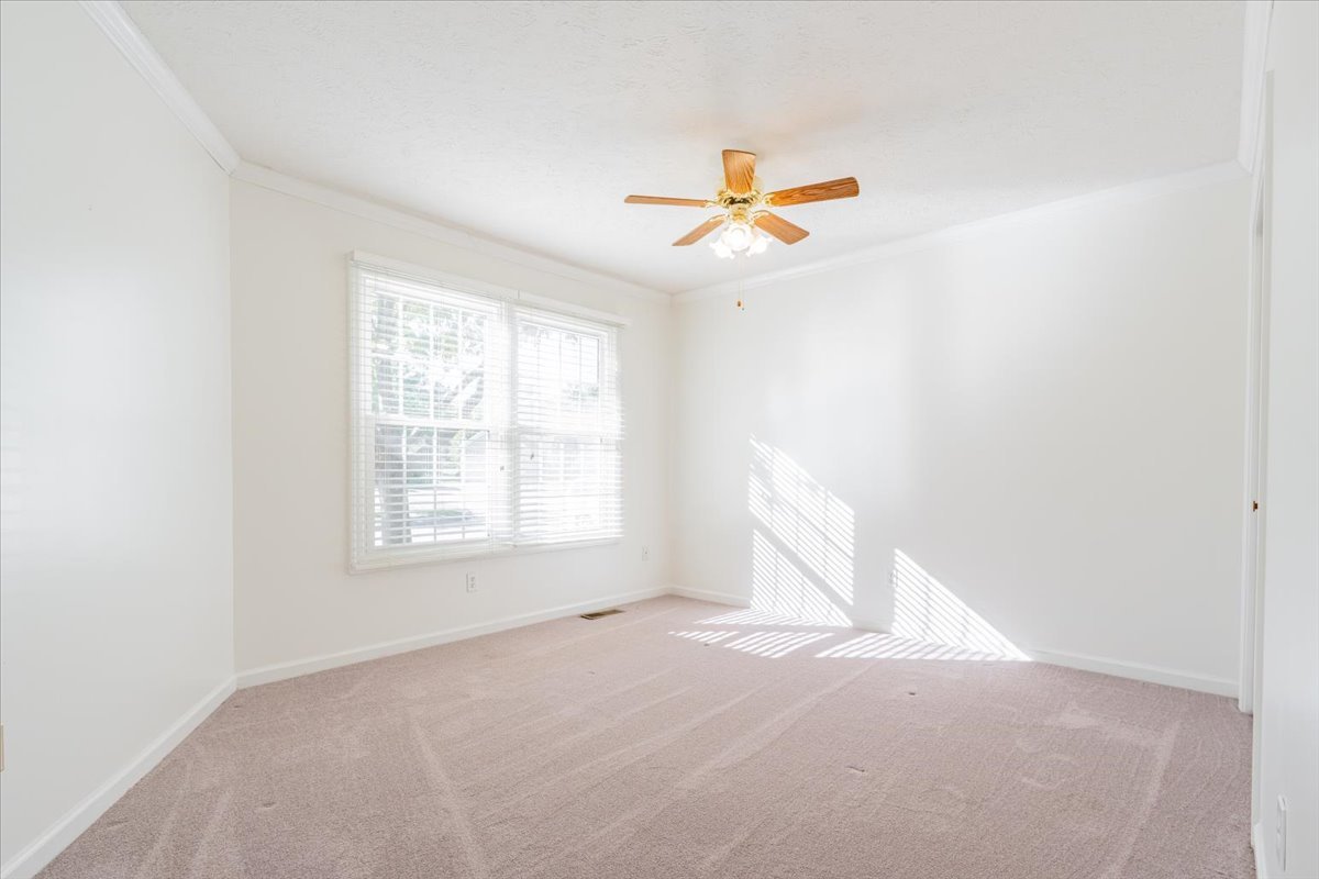 107 North Blair Drive, Unit 8 Normal, IL 61761 - Photo 18 of 29 an empty room with windows and fan