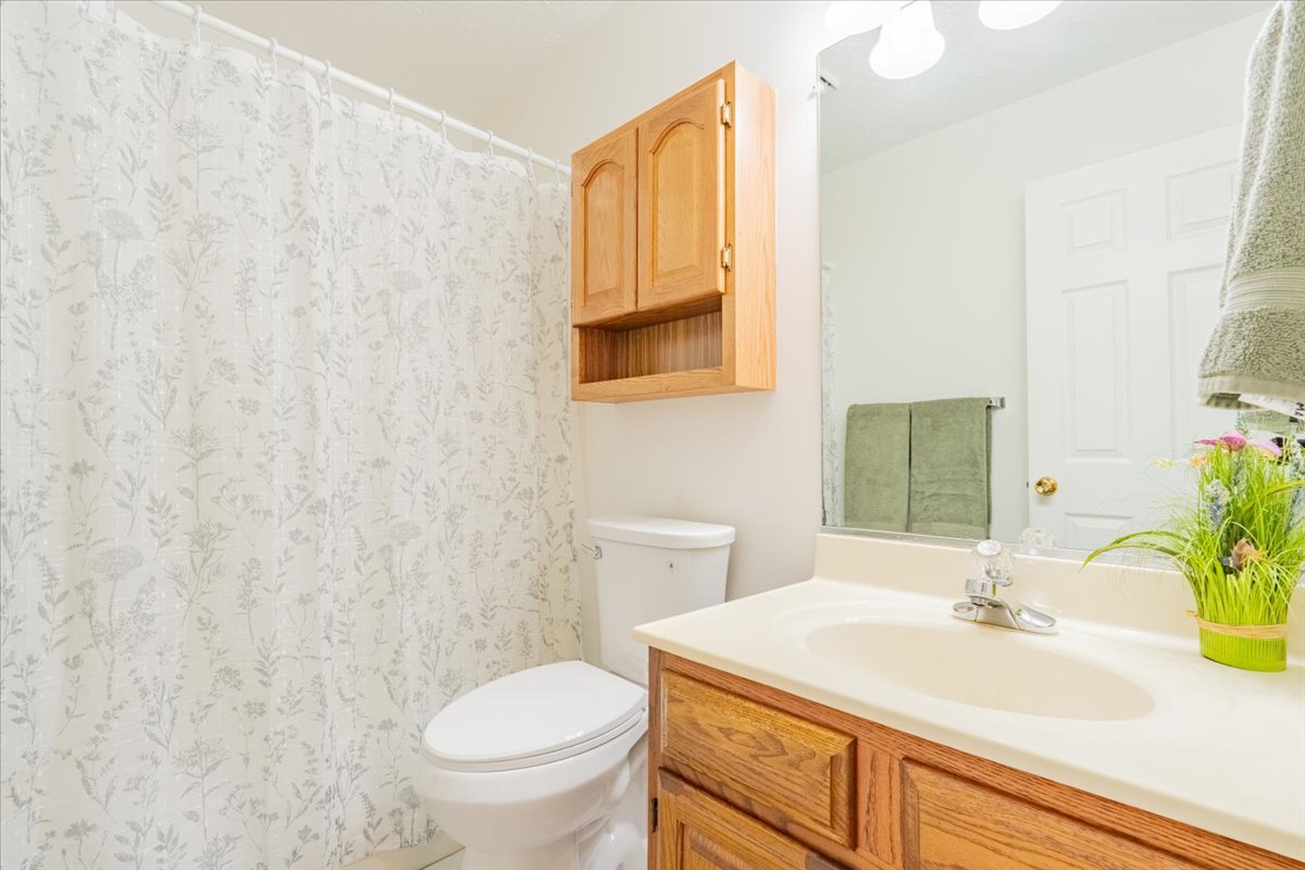 107 North Blair Drive, Unit 8 Normal, IL 61761 - Photo 20 of 29 a bathroom with a sink a toilet and a mirror