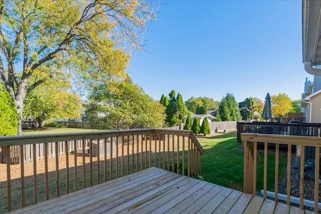 a balcony with wooden floor and fence