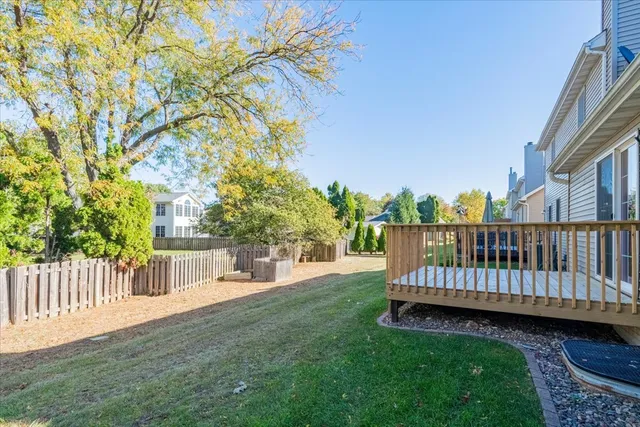 a view of a tennis ground with large trees