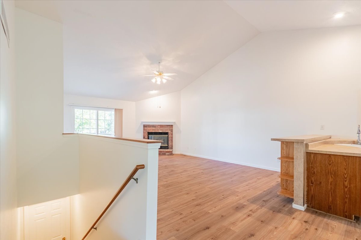 107 North Blair Drive, Unit 8 Normal, IL 61761 - Photo 5 of 29 a view of a kitchen with wooden floor and a ceiling fan