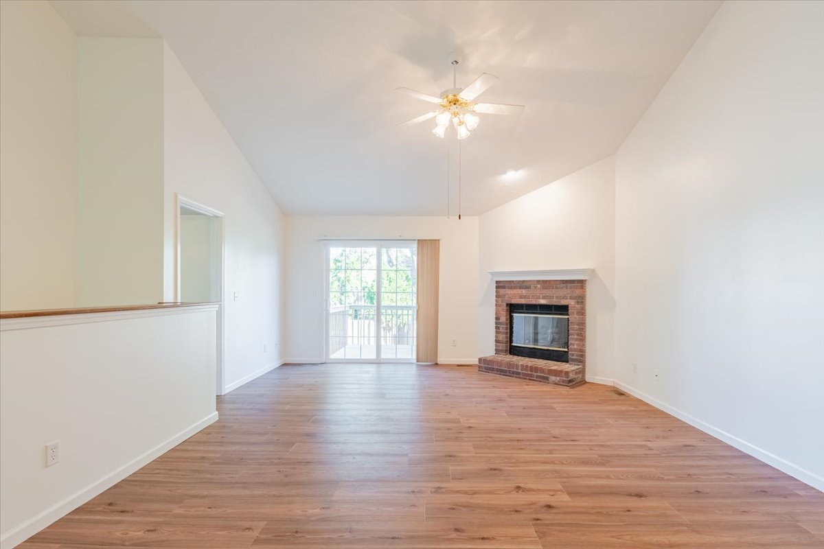 107 North Blair Drive, Unit 8 Normal, IL 61761 - Photo 9 of 29 a view of an empty room with wooden floor and a window