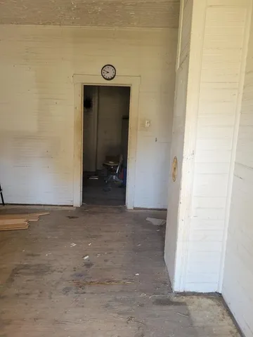 a room with wooden floor and gym equipment