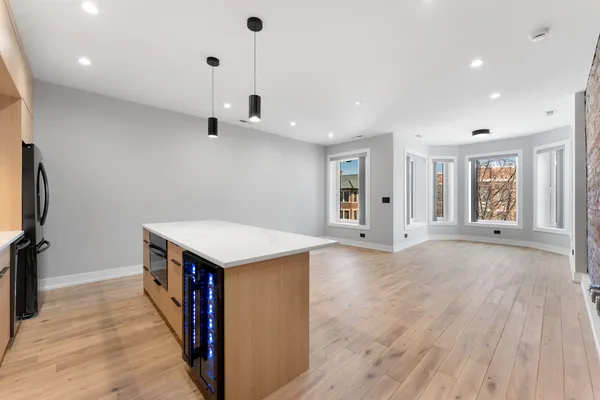 a view of a kitchen with a sink and a refrigerator