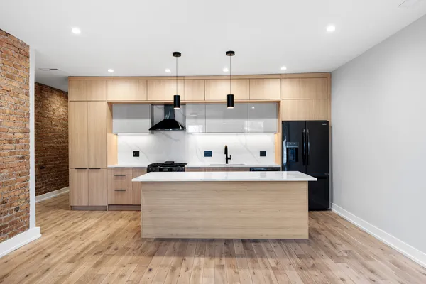 a kitchen with stainless steel appliances granite countertop a stove and a refrigerator