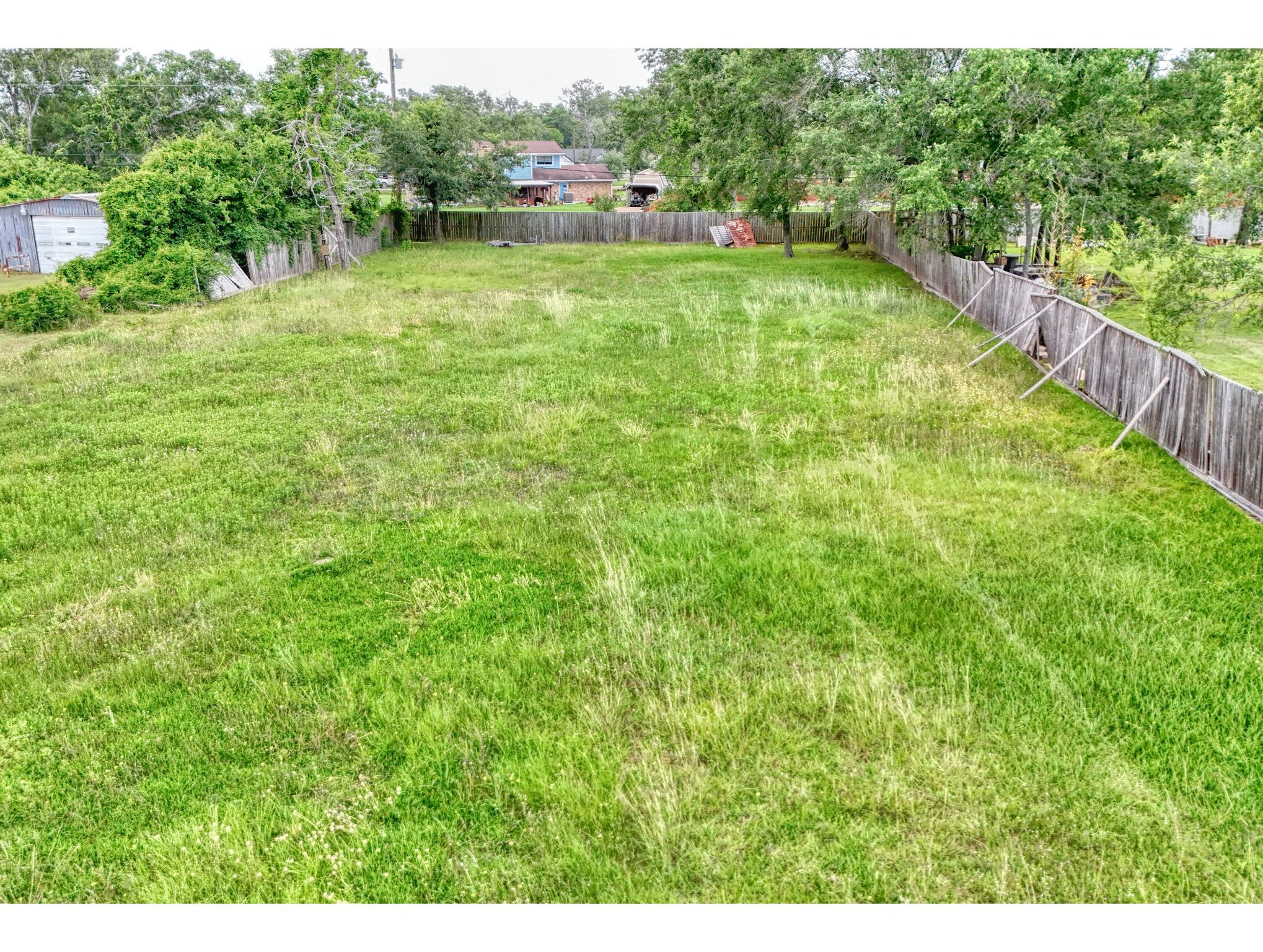2720 Red Bluff Road Seabrook, TX 77586 - Photo 5 of 6 a view of a green field with wooden fence