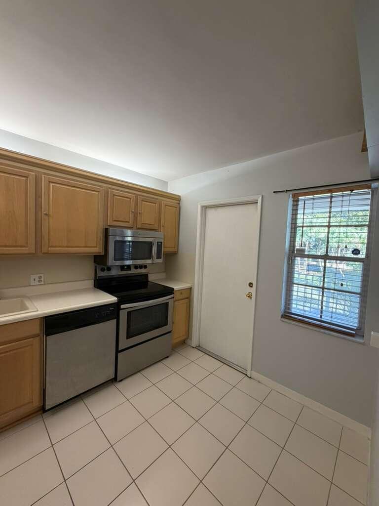2601 South Course Drive, Unit 203 Pompano Beach, FL 33069 - Photo 14 of 33 a view of a kitchen with windows