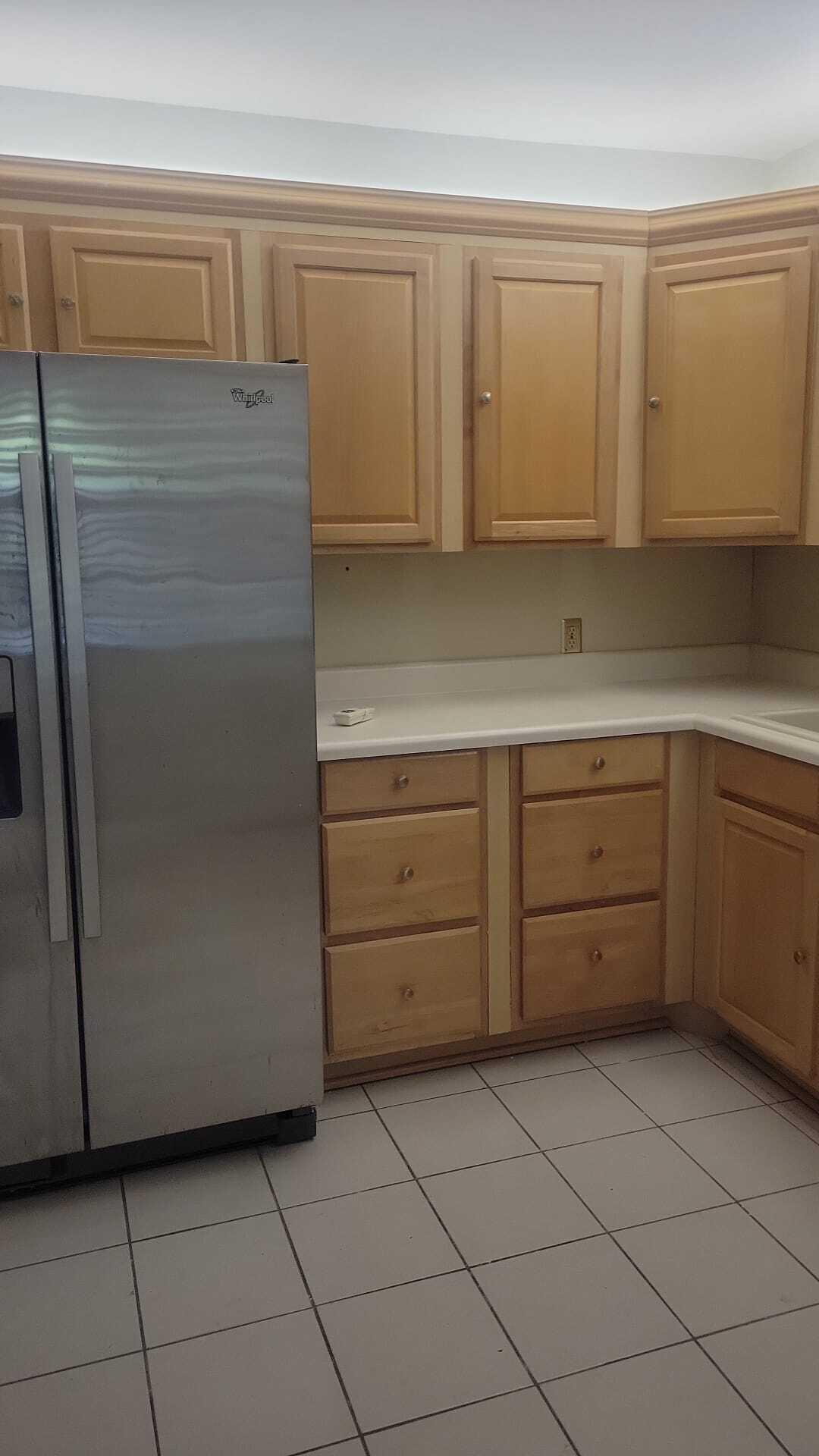 2601 South Course Drive, Unit 203 Pompano Beach, FL 33069 - Photo 15 of 33 a kitchen with a cabinets and white stainless steel appliances