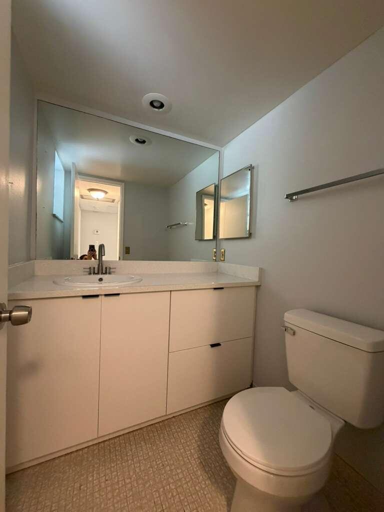 2601 South Course Drive, Unit 203 Pompano Beach, FL 33069 - Photo 17 of 33 a bathroom with a toilet sink and mirror