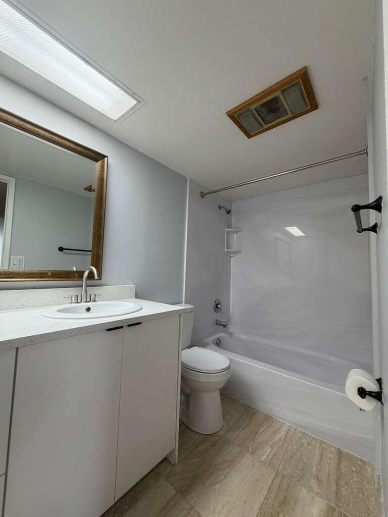 2601 South Course Drive, Unit 203 Pompano Beach, FL 33069 - Photo 22 of 33 a bathroom with a sink mirror toilet and bathtub