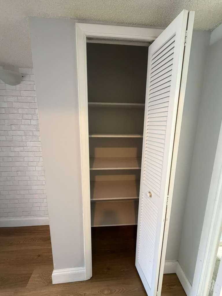 2601 South Course Drive, Unit 203 Pompano Beach, FL 33069 - Photo 23 of 33 a view of walk in closet with empty racks