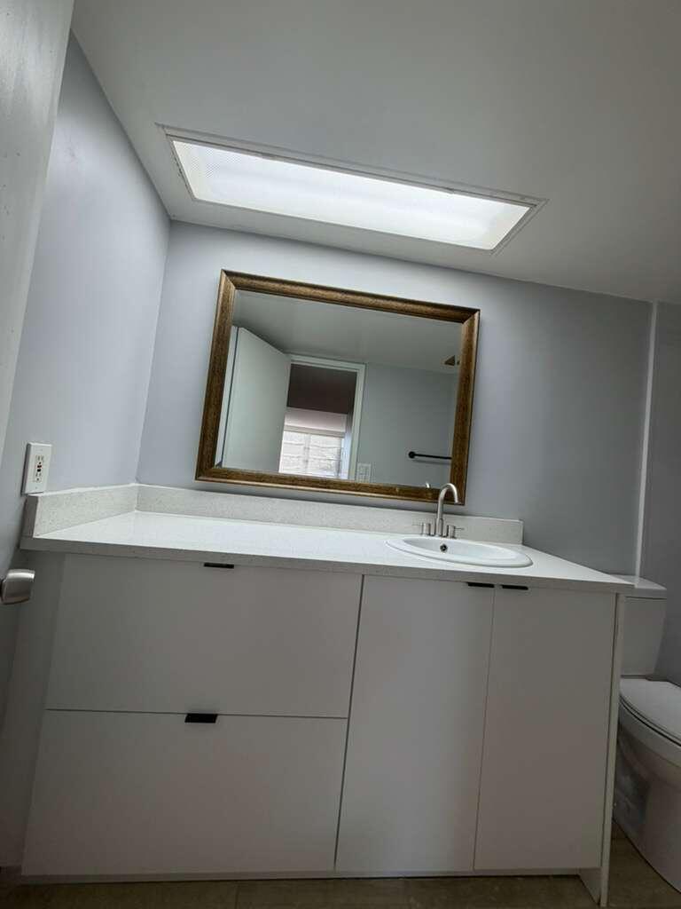 2601 South Course Drive, Unit 203 Pompano Beach, FL 33069 - Photo 25 of 33 a living room with a sink and mirror