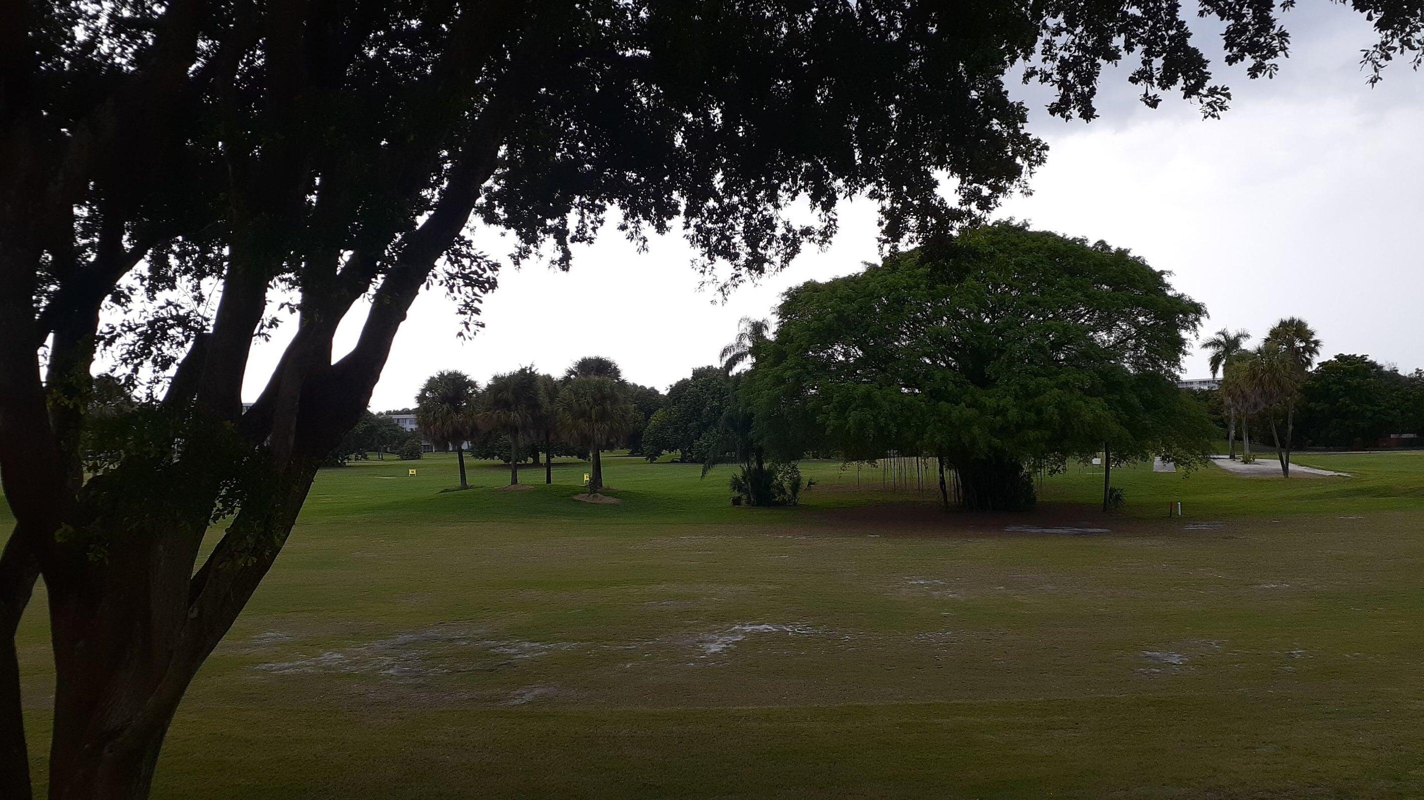 2601 South Course Drive, Unit 203 Pompano Beach, FL 33069 - Photo 29 of 33 a view of a field of grass and a tree