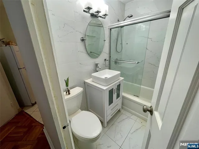 a bathroom with a toilet sink and shower