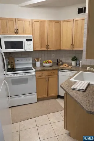 a kitchen with a stove a sink and a microwave