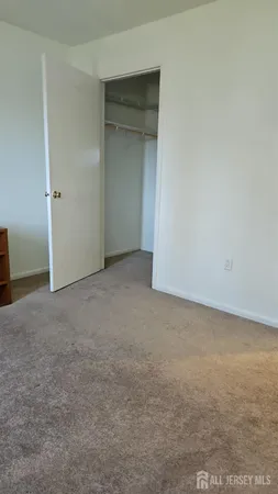 an empty room with an entrance to other room