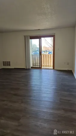 an empty room with wooden floor