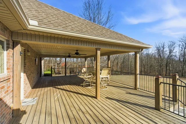 a view of empty room with wooden floor and fireplace
