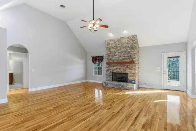 a kitchen with stainless steel appliances granite countertop wooden cabinets a sink and dishwasher a stove with wooden floor