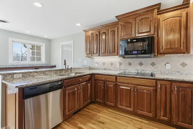 a kitchen with a refrigerator and chair