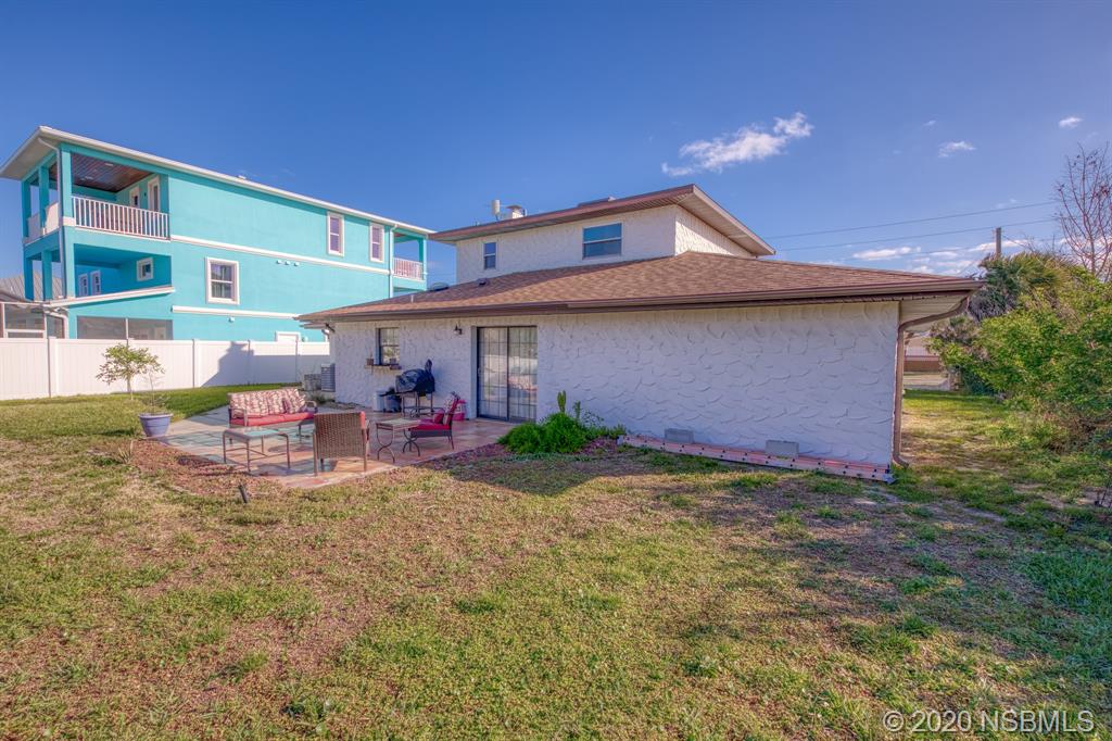 4718 South Atlantic Avenue Ponce Inlet, FL 32127 - Photo 20 of 22 a view of a house with backyard porch and furniture