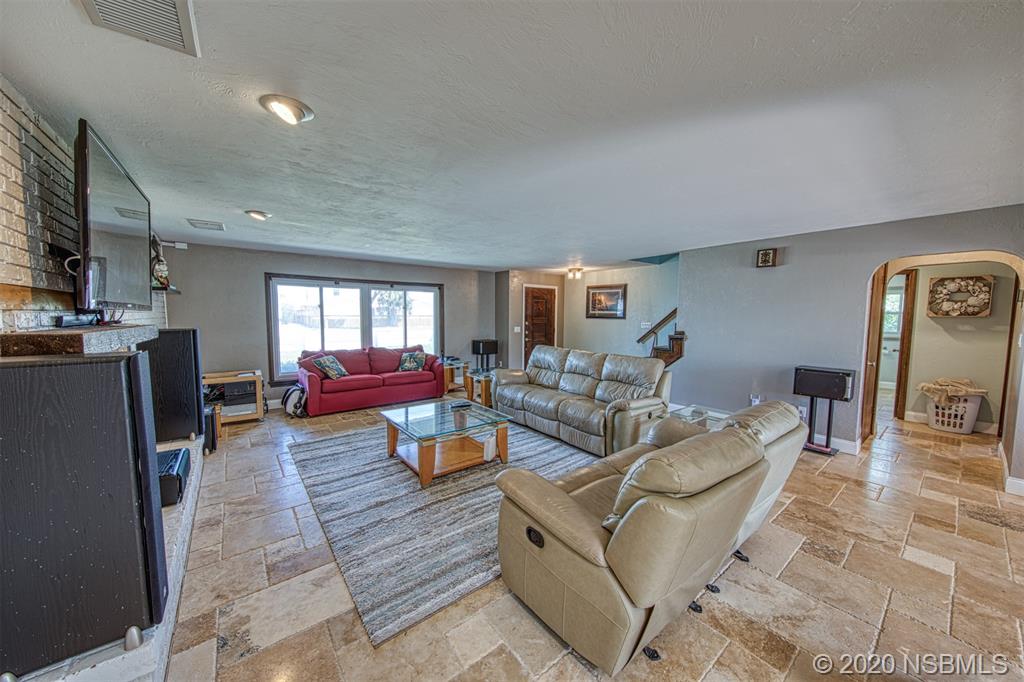 4718 South Atlantic Avenue Ponce Inlet, FL 32127 - Photo 5 of 22 a living room with furniture and a flat screen tv