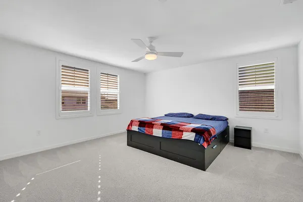 a bedroom with a bed and a painting on the wall