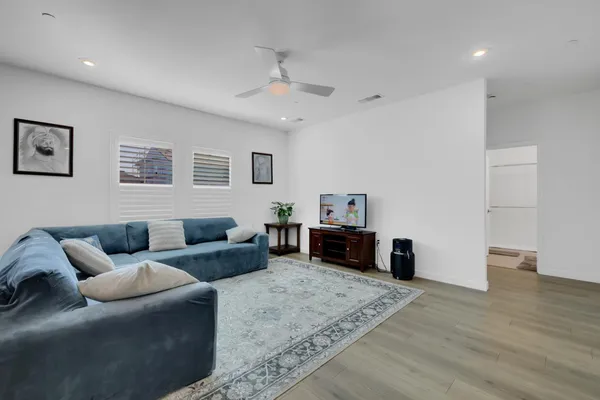 a living room with furniture and kitchen view