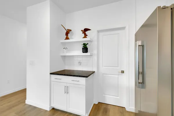 a kitchen with stainless steel appliances granite countertop a sink refrigerator and microwave