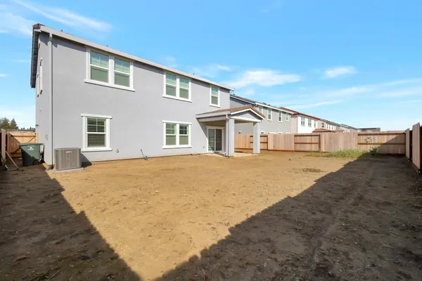 a view of a house with a backyard and a tub