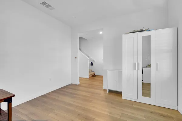 a view of empty room with wooden floor