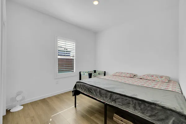 a bedroom with a bed and a window