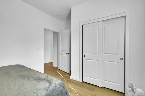 a bedroom with a bed and hallway