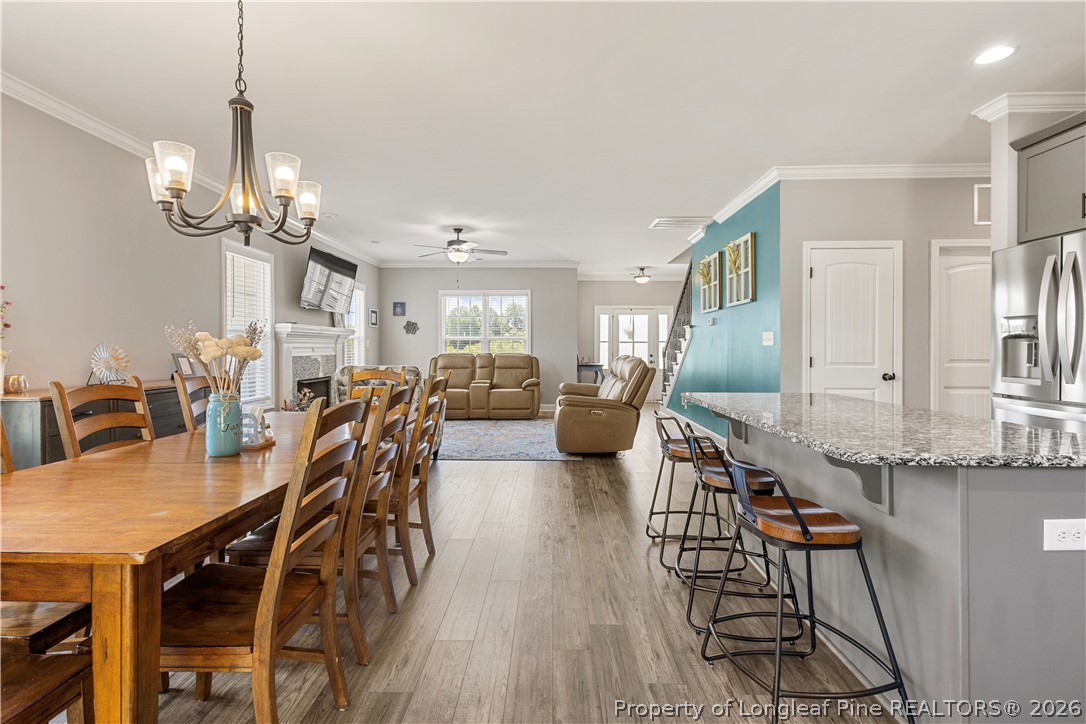 137 Minter School Road Sanford, NC 27332 - Photo 6 of 50 a view of a dining room with furniture a chandelier and wooden floor
