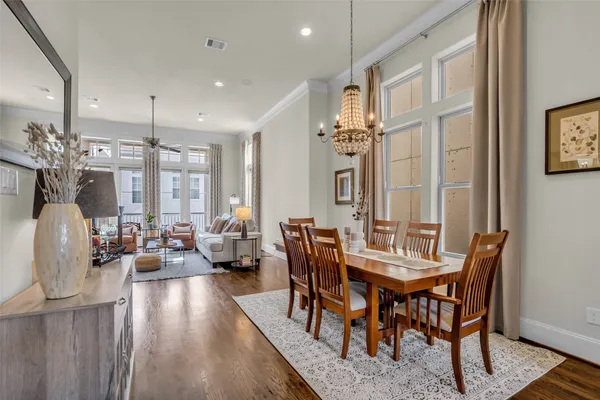 a view of a a dining room with furniture window and wooden floor