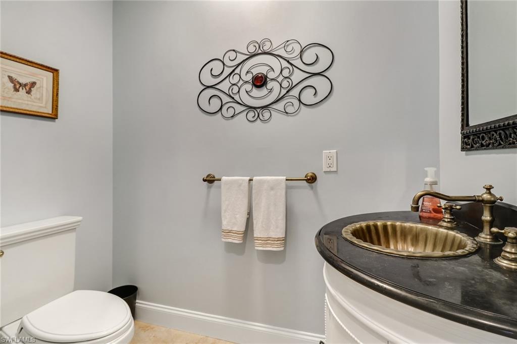 401 Bayfront Place, Unit 3408 Naples, FL 34102 - Photo 15 of 26 a bathroom with a sink a toilet and mirror