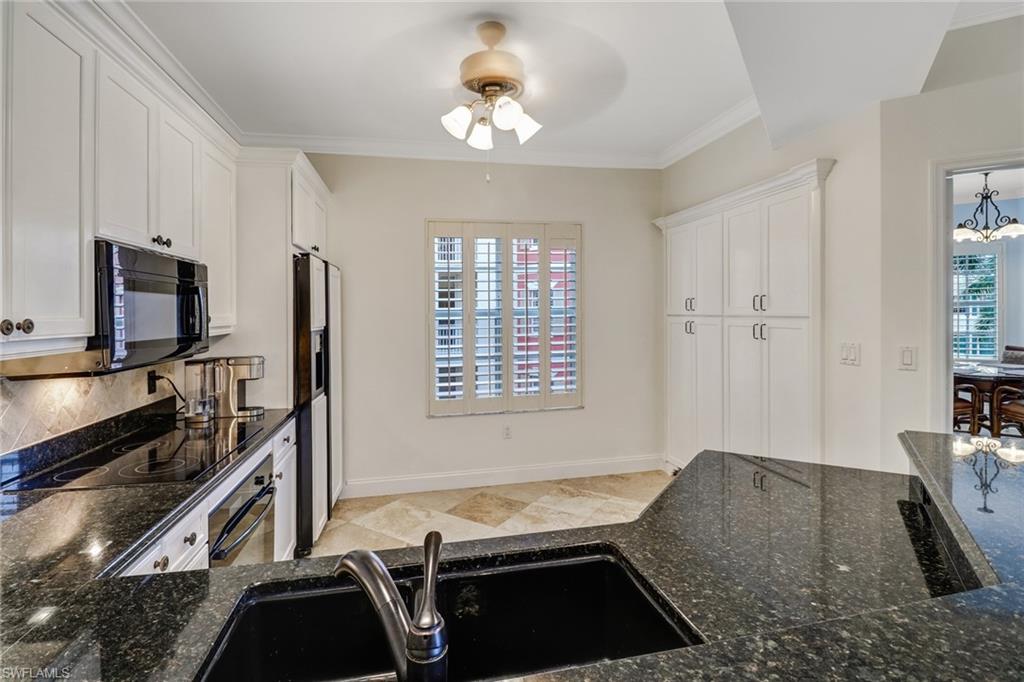 401 Bayfront Place, Unit 3408 Naples, FL 34102 - Photo 5 of 26 a kitchen with granite countertop a stove a sink and a refrigerator