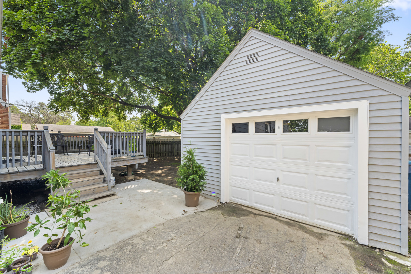 660 1st Street Crete, IL 60417 - Photo 16 of 23 a view of a patio with table and chairs and potted plants