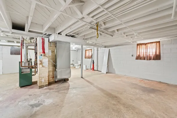 a view of a hallway with closet and chandelier