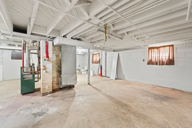 a view of a hallway with closet and chandelier