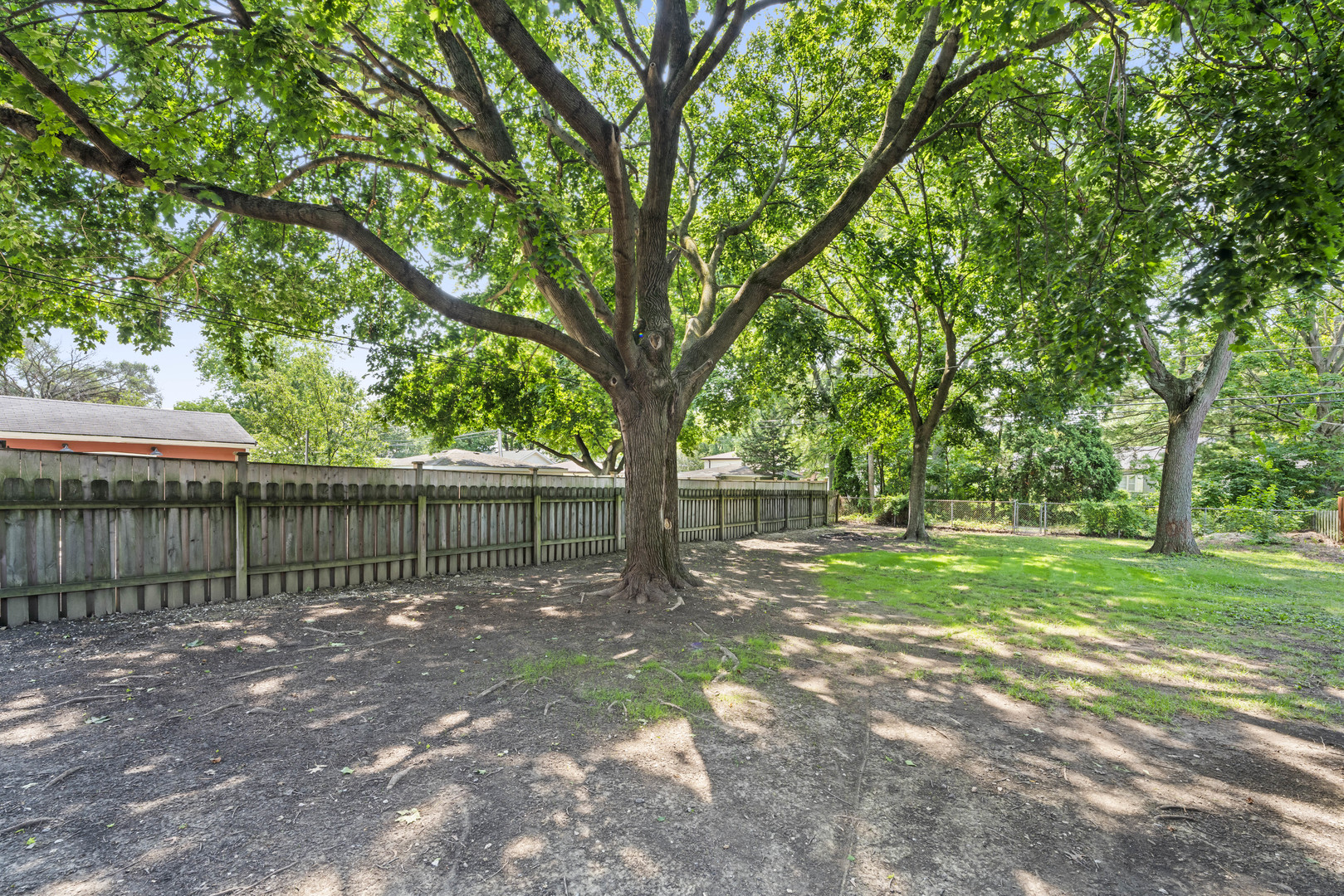 660 1st Street Crete, IL 60417 - Photo 23 of 23 a view of a yard with large trees and a barn in it