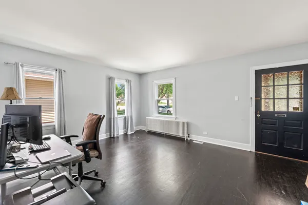 a view of a workspace with furniture and a window