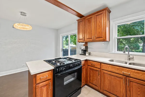 a kitchen with stainless steel appliances granite countertop a sink stove and cabinets