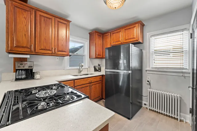 a kitchen with stainless steel appliances granite countertop a stove a refrigerator and a sink