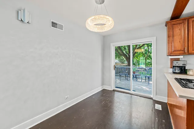 a view of a kitchen with wooden floor and a window
