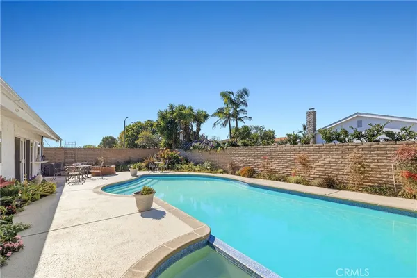 a view of house with swimming pool yard and outdoor seating