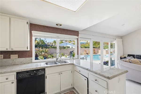 a kitchen with a sink a stove and cabinets