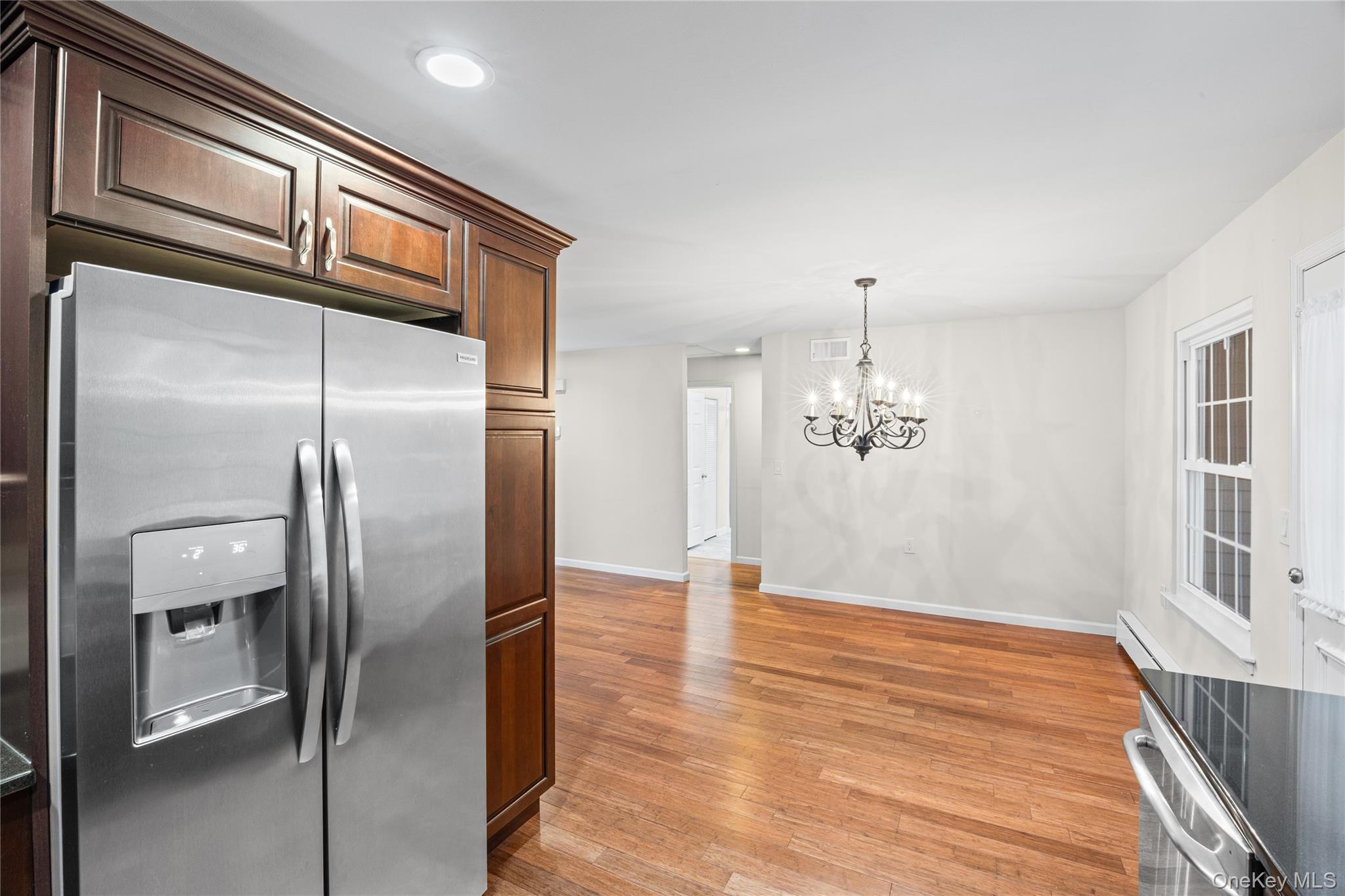 220 Belfast Lane Ridge, NY 11961 - Photo 25 of 44 a view of kitchen with refrigerator and wooden floor